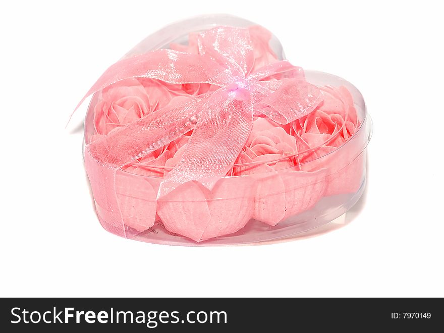 Pink little roses are in the plastic heart box. Pink little roses are in the plastic heart box.