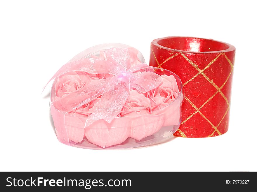 Pink little roses are in the plastic heart box with red candle. Pink little roses are in the plastic heart box with red candle.