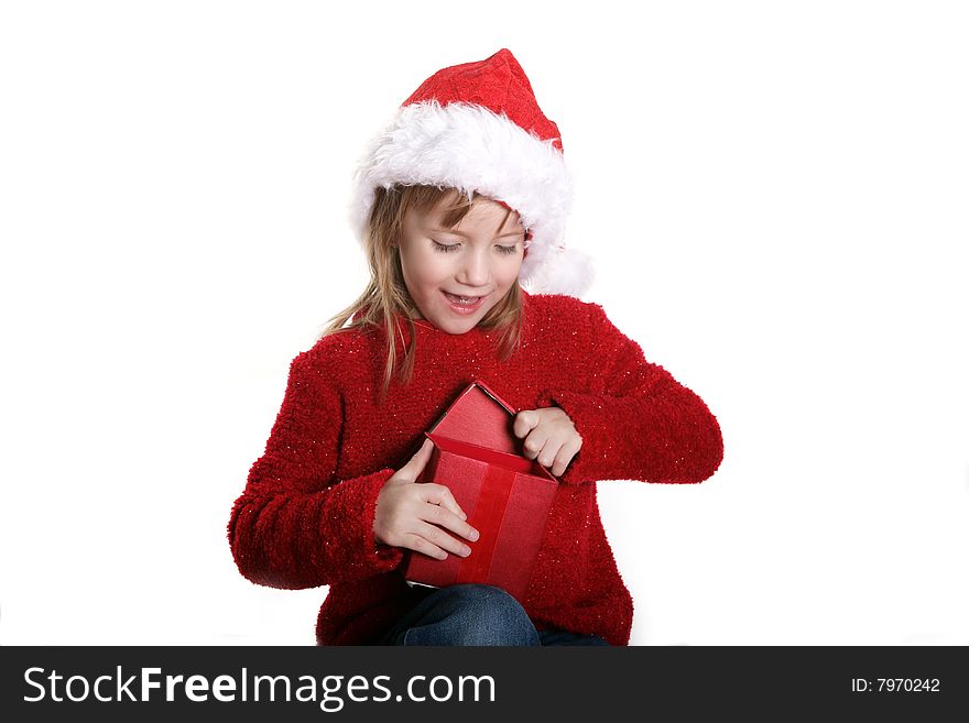A four year old girl opening a gift