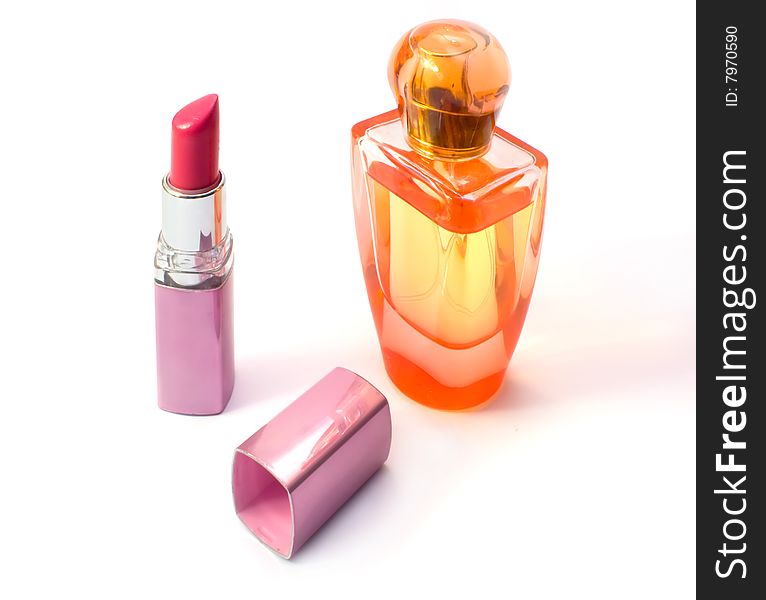 Lipstick and perfume bottle. Photo close up on a white background.
