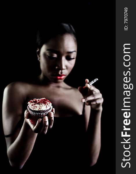 A young model with cupcake, photographed in the studio.