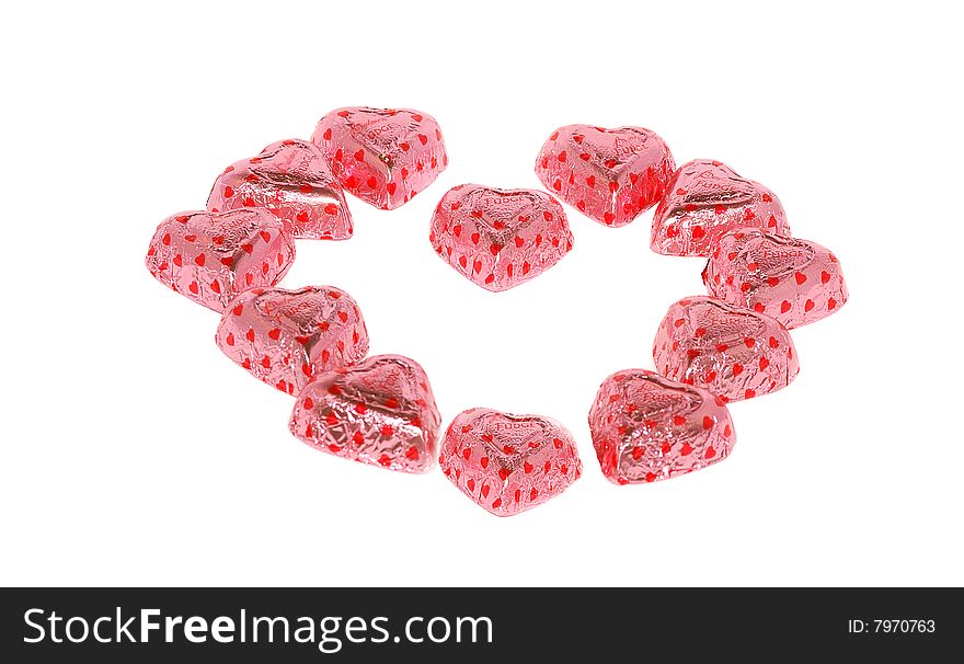 Sweets in pink papers isolated on the white. Sweets in pink papers isolated on the white.