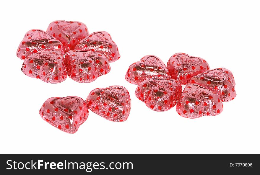 Sweets in pink papers isolated on the white as little lucky flowers. Sweets in pink papers isolated on the white as little lucky flowers.