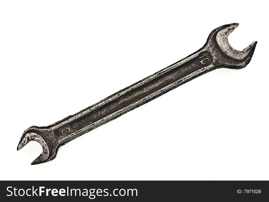 Old spanner on white background