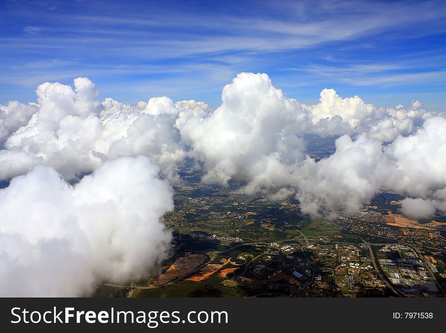 Aerial view of cloudscape over a cityscape.