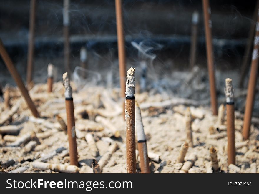 Incense sticks burning in urn at a temple