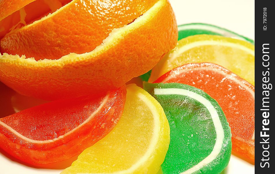 Orange, yellow and green fruit and candy slices. Orange, yellow and green fruit and candy slices