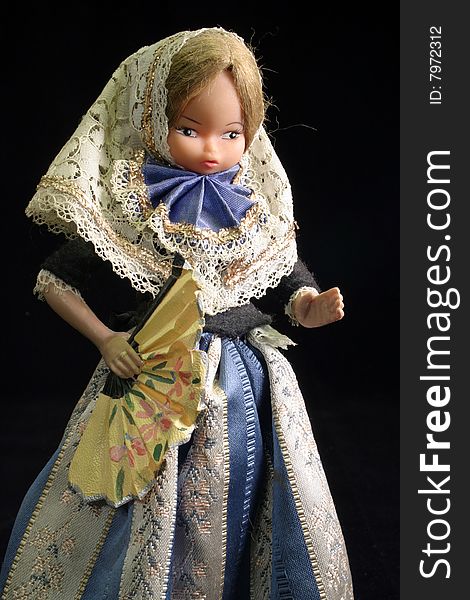Beautiful Spanish doll in a blue dress holding a fan. Beautiful Spanish doll in a blue dress holding a fan