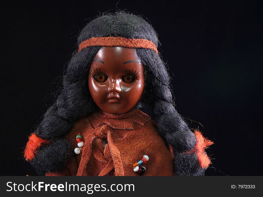 Native American Indian doll on black background