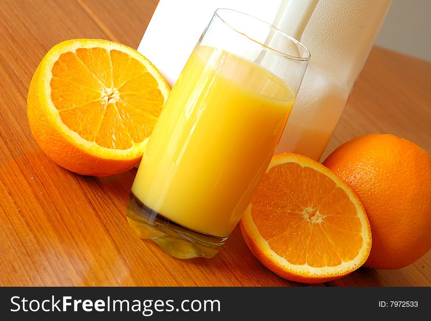 An image of orange juice and oranges on an angle. An image of orange juice and oranges on an angle.