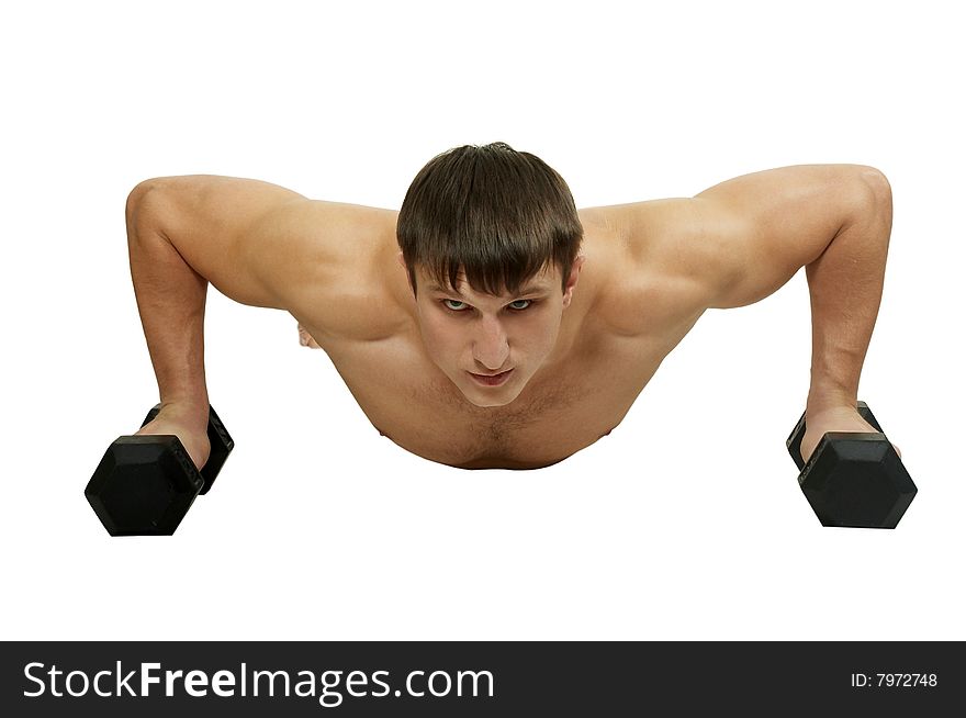 The young man does exercise with dumbbell. The young man does exercise with dumbbell