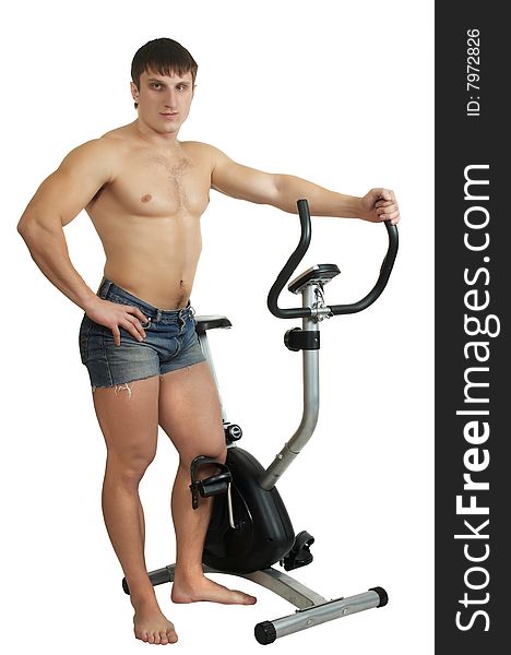 Man stands near to  exercise bicycle