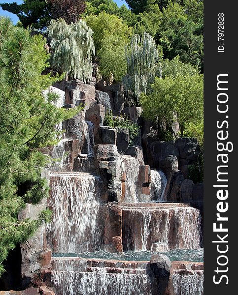 A lush waterfall in the middle of green pine trees