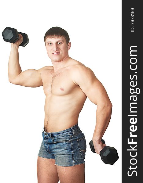 The man does(makes) gymnastic exercises with dumbbell. The man does(makes) gymnastic exercises with dumbbell