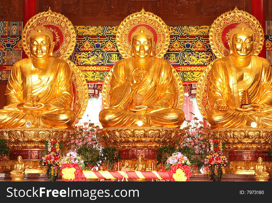 Three Golden Buddha images in main pavilion of Chinese temple, Nonthaburi, Thailand. Three Golden Buddha images in main pavilion of Chinese temple, Nonthaburi, Thailand