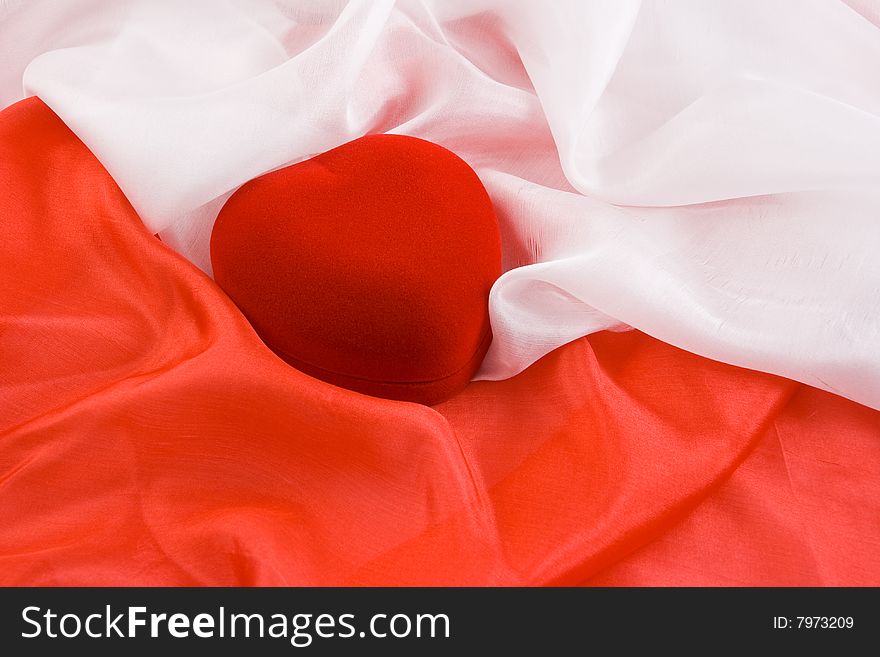 Velvet jewel-box in form of heart on the red and white silk. Velvet jewel-box in form of heart on the red and white silk
