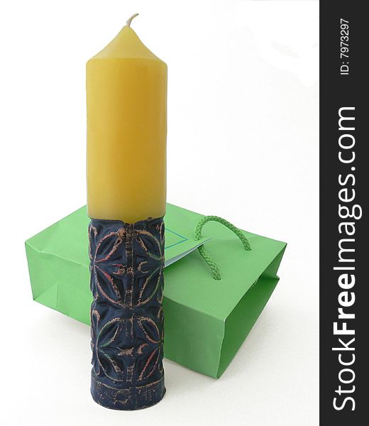 It \' s an art candle with green packet over white background