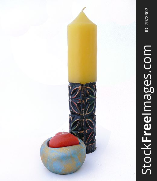 Valentine candle and yellow candle over white background. Valentine candle and yellow candle over white background