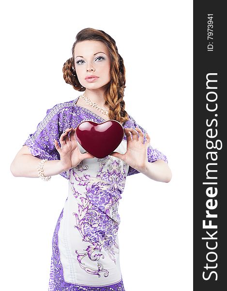 Beautiful romantic woman holding a dark red heart, isolated on white