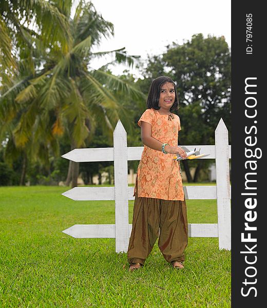 Asian kid in the park with her toy aeroplane