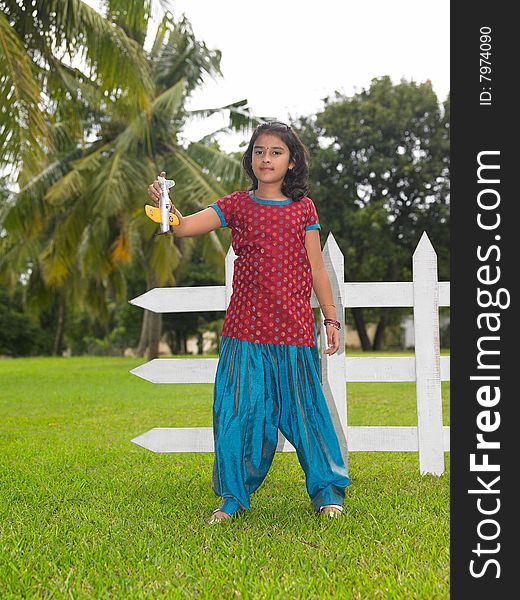 Kid In The Park With Her Toy Aeroplane