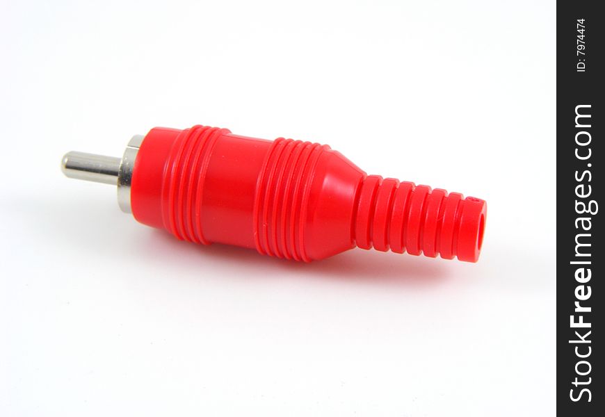 Red phono style plug on a plain background. Red phono style plug on a plain background