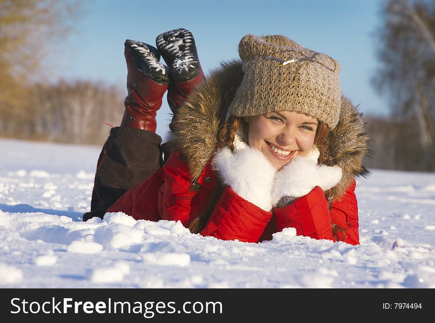 Attractive Girl Lays On Snow And Smiles