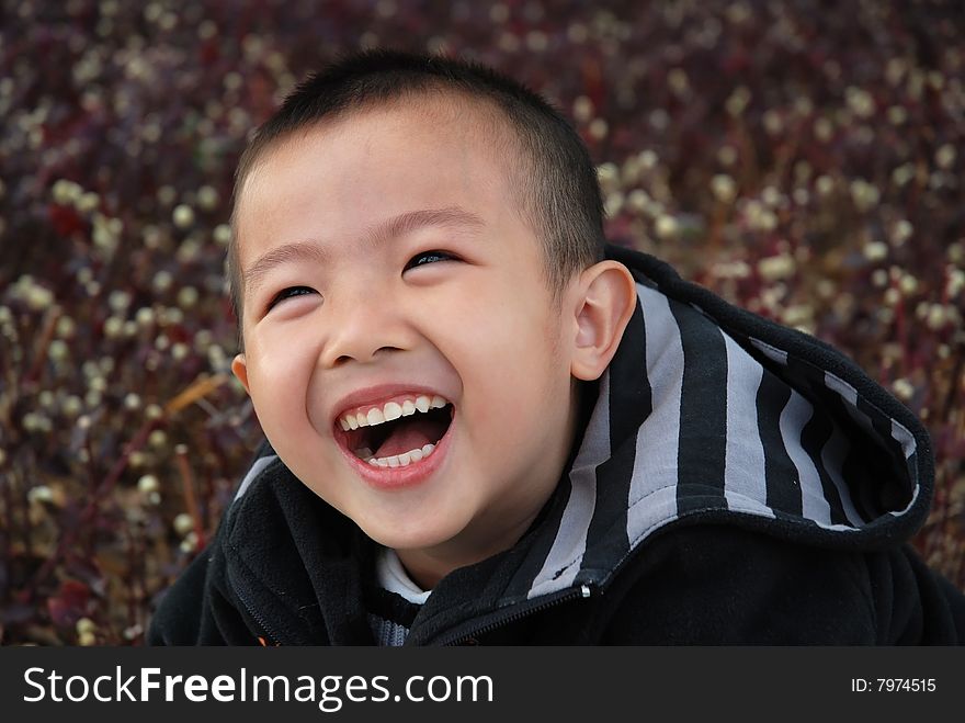 Young boy playing cheerfully in the garden