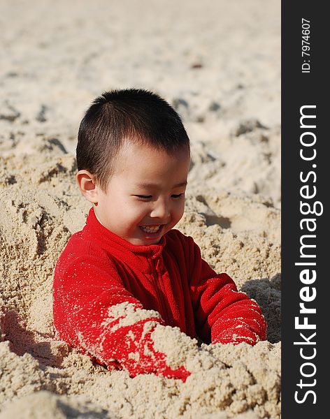 Young Boy Playing joyfully in sunny beach. Young Boy Playing joyfully in sunny beach