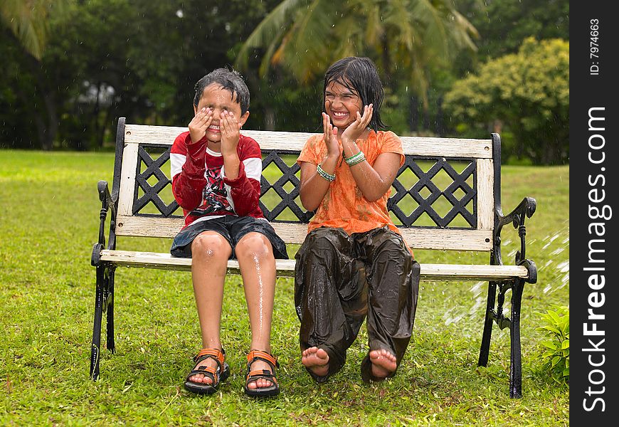 Asian kids playing in the rain