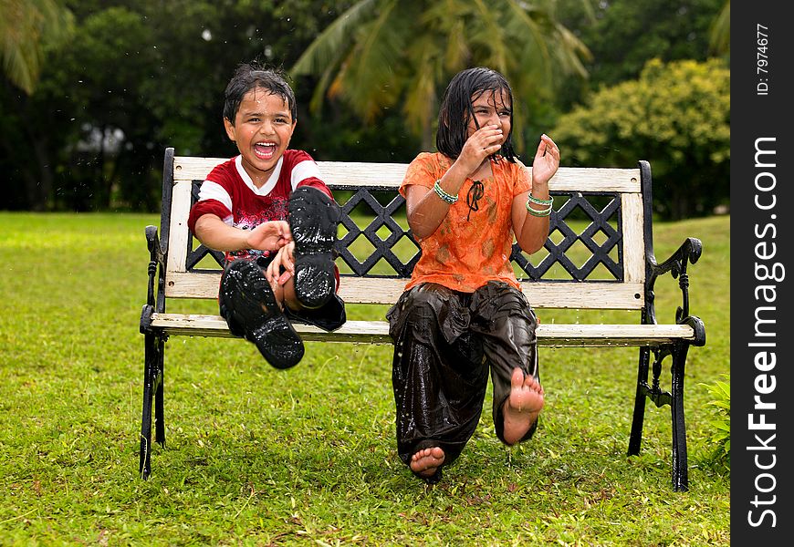 Asian origin kids playing in the rain