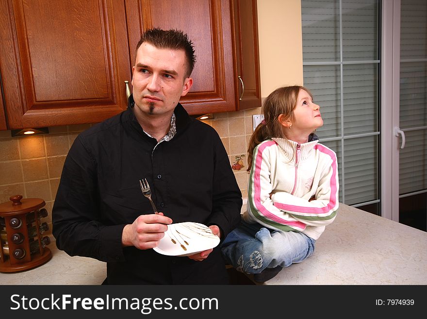 Father and his naughty daughter in the kitchen. Father and his naughty daughter in the kitchen.