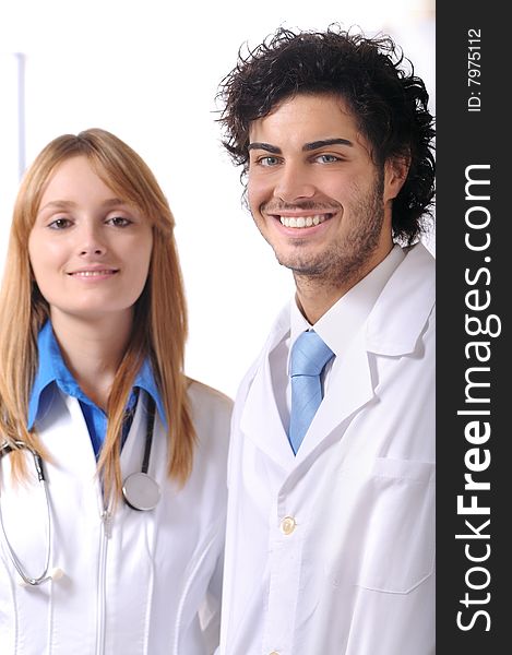 Young doctor with stethoscope smiles and look in camera. Young doctor with stethoscope smiles and look in camera