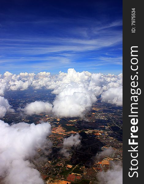 Aerial view of cloudscape over a cityscape.