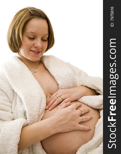 Pregnant woman holding her belly in white dress