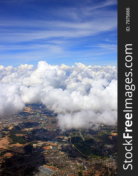 Aerial view of cloudscape over a cityscape.
