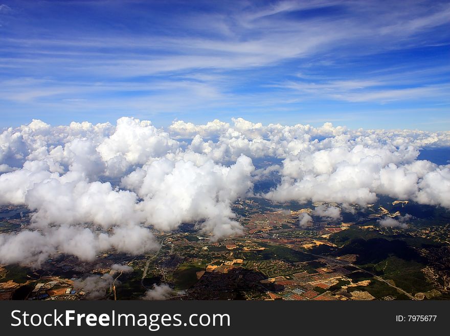 Aerial view of cloudscape over a cityscape.