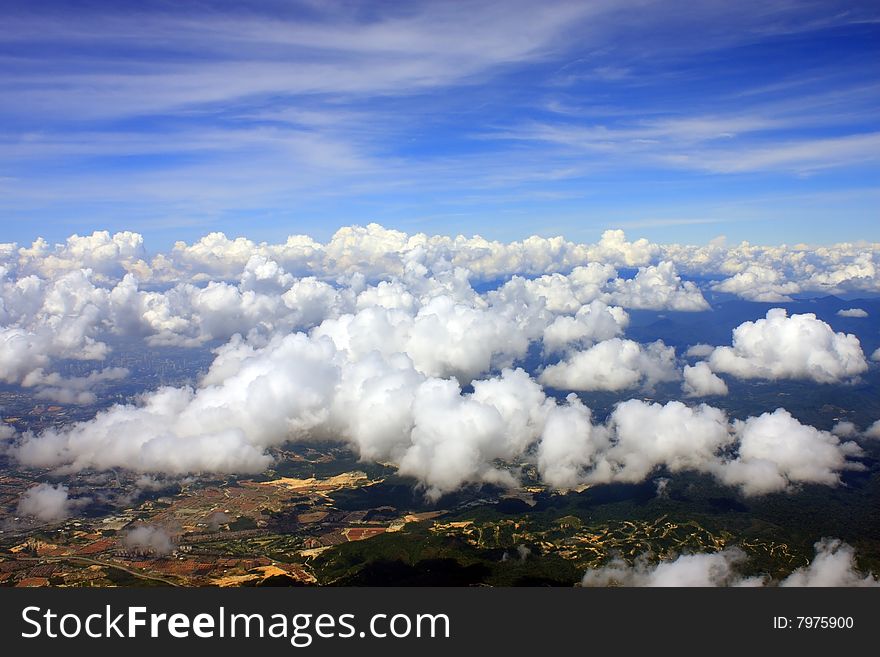 Aerial view of cloudscape over a cityscape.