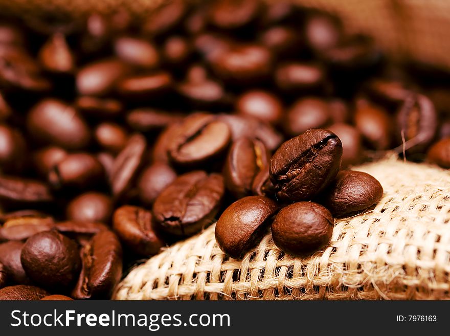 Inside burlap bag filled with coffee beans - selected focus. Inside burlap bag filled with coffee beans - selected focus