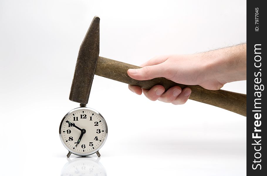 Male hand with hammer and alarm-clock. Male hand with hammer and alarm-clock