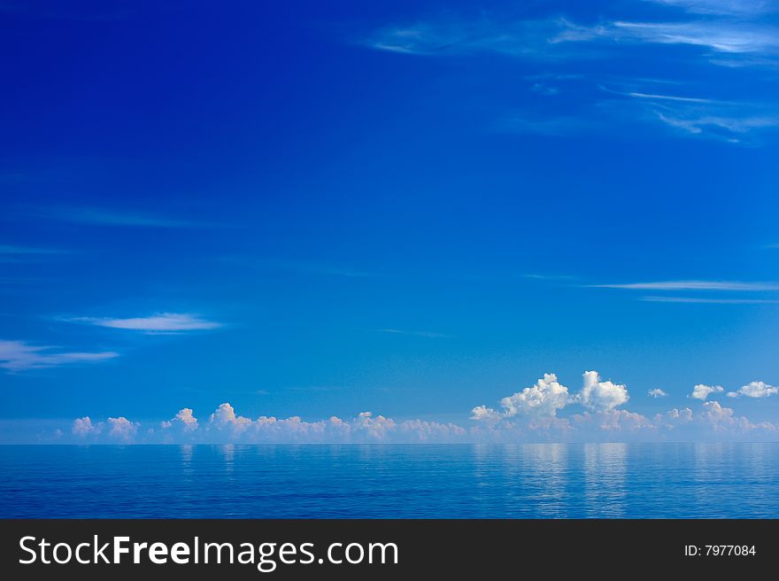 Silent summer morning on the sea with white clouds