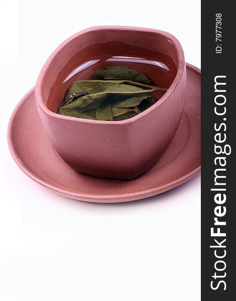 A cup of tea is on white background.
This is traditional Chinese tea.