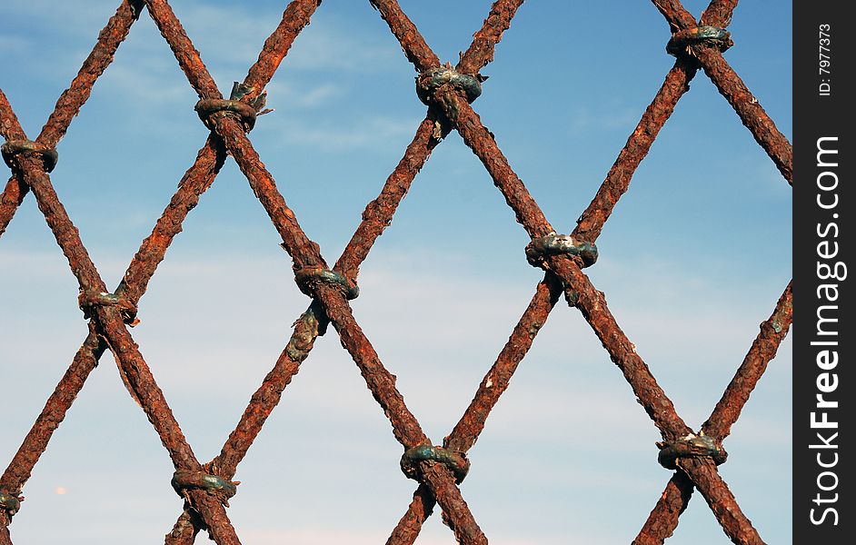 Rusty grates with blue sky on the background