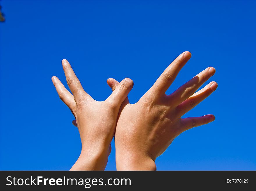 Heands reaching out over blue background. Heands reaching out over blue background