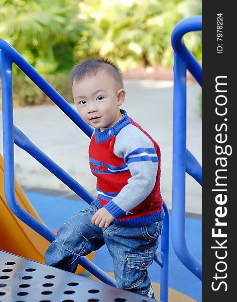 Bright picture of adorable chinese baby boy in the playground. Bright picture of adorable chinese baby boy in the playground