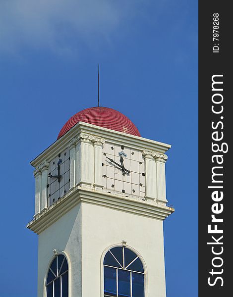 A clock tower with blue sky background. A clock tower with blue sky background