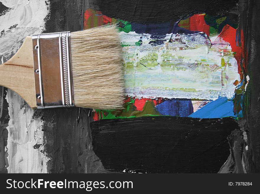 The image of an abstract picture and brushes of the artist laying on it. The image of an abstract picture and brushes of the artist laying on it.