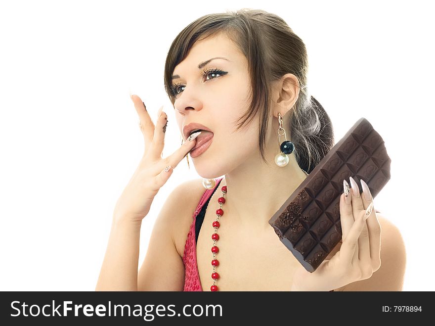 Beautiful young brunette woman eating a bar of chocolate. Beautiful young brunette woman eating a bar of chocolate