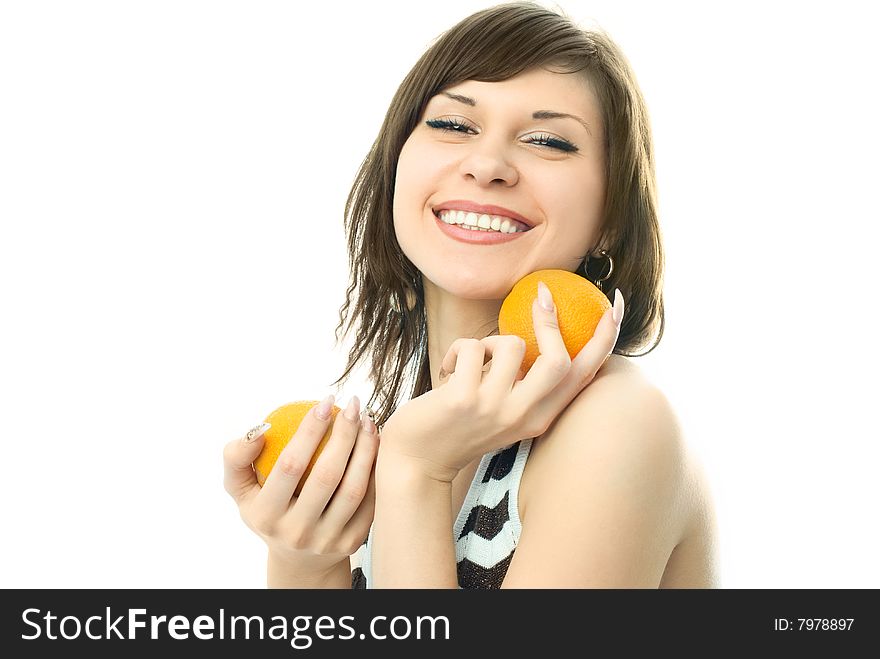 Happy beautiful young woman with oranges in her hands