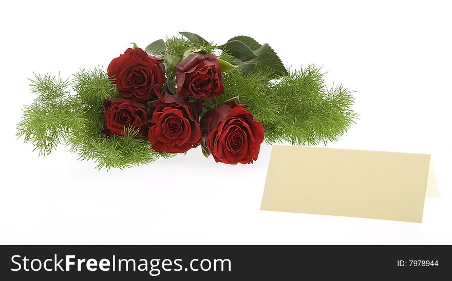 Red roses with a cream-colored place card, symbol for the valentine day, mother day, wedding day or birthday